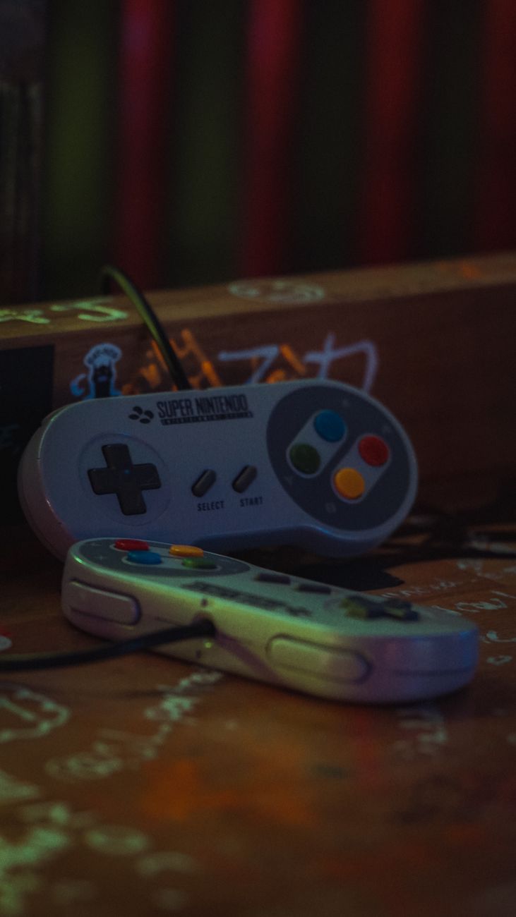 Close-up view of mechanical gaming keyboard and custom retro console controller