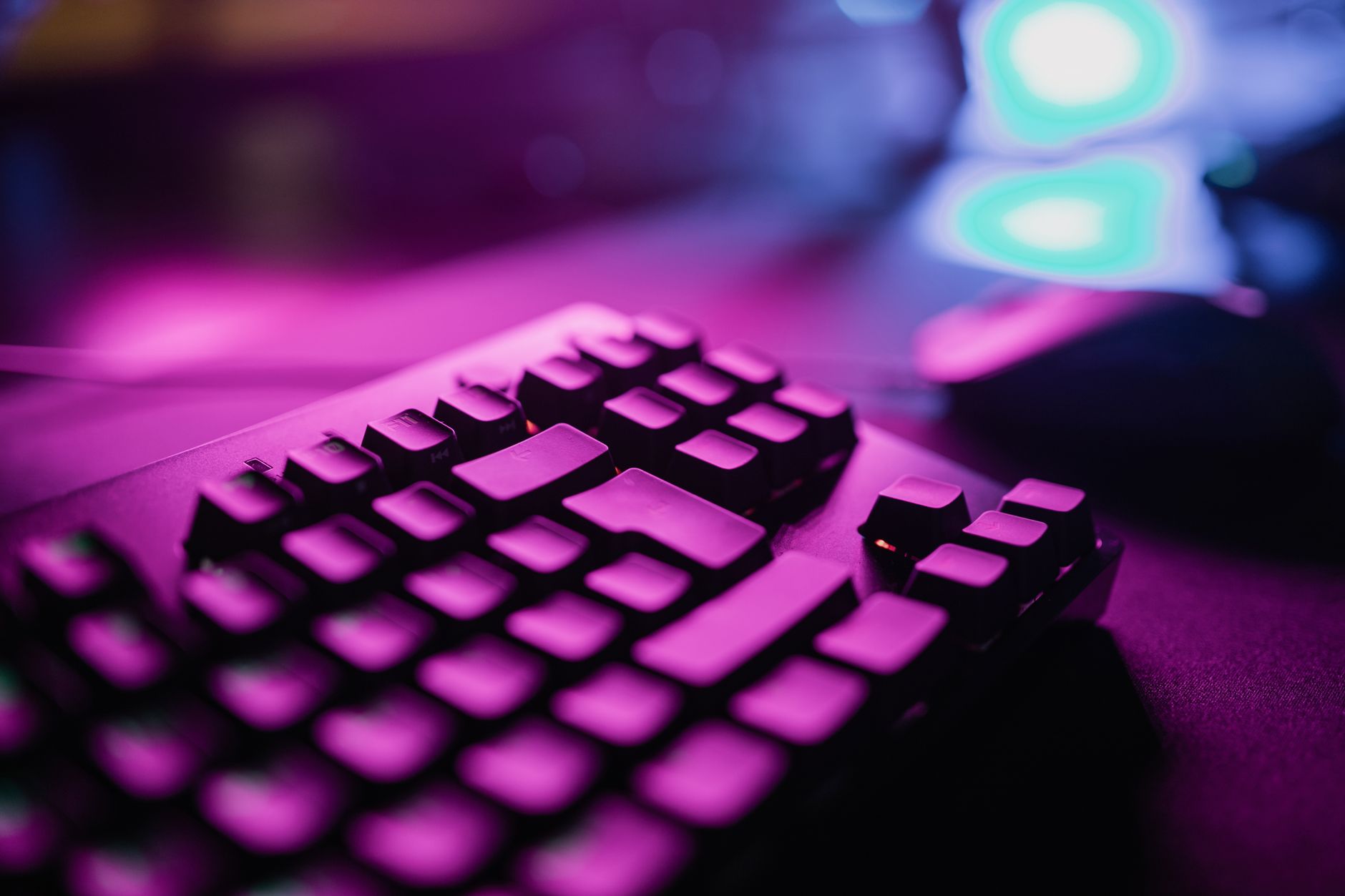Modern gaming setup and glowing monitors under neon lighting